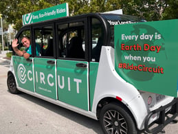 driver waving back from earth day car