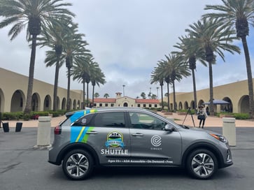 A circuit Kia shuttle in frony of Chula Vista City Hall