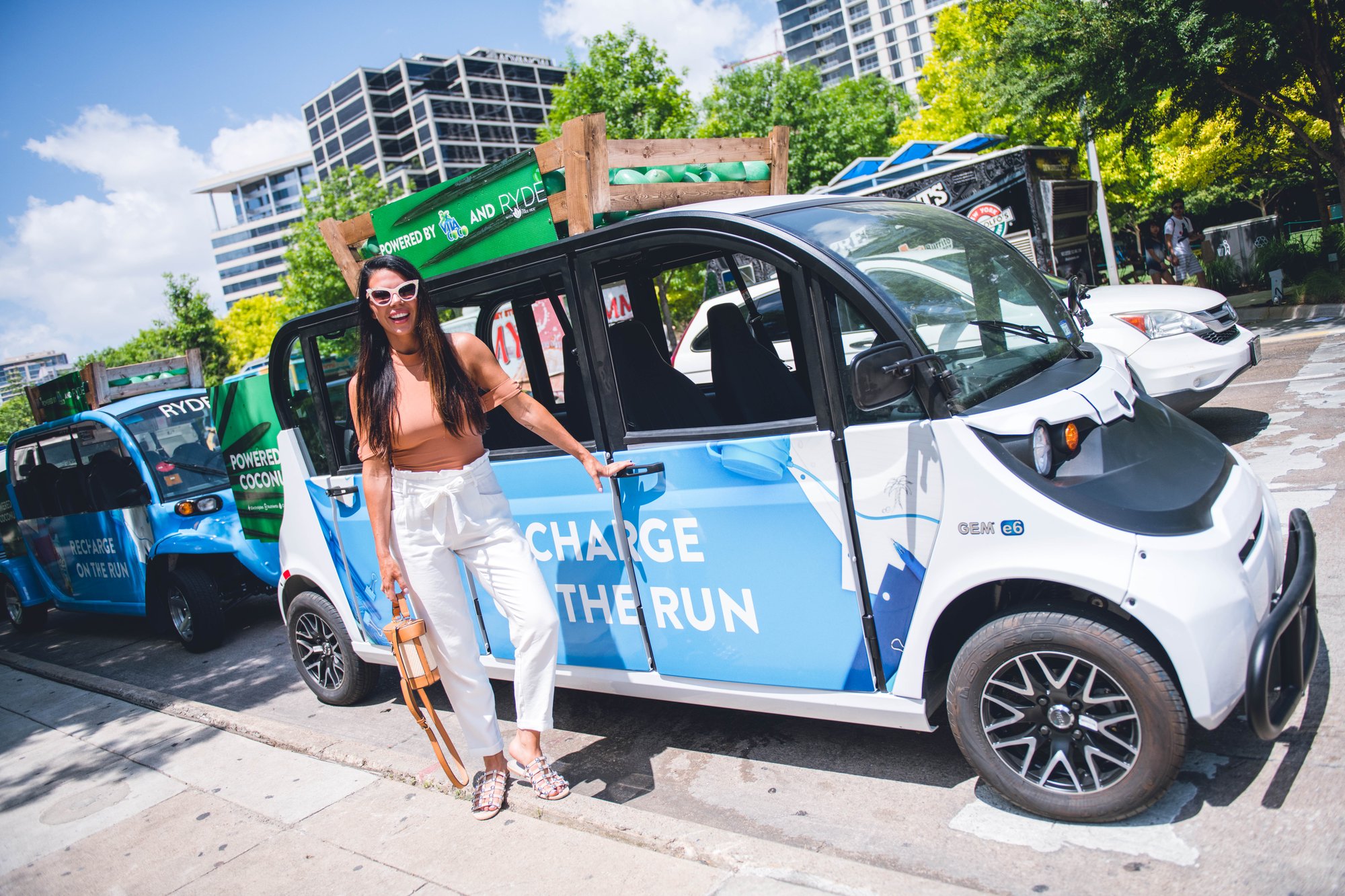 Woman standing in front of a Vita Coco branded Circuit car.