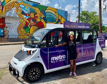 Woman posing with a metro by t-mobile braded circuit car