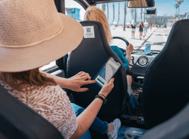 Woman looking at the Circuit app while riding in a Circuit car.