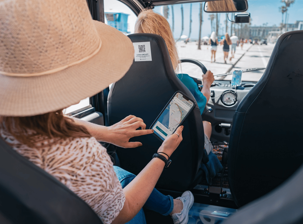 Woman viewing Circuit app while riding in a Circuit car Woman viewing Circuit app while riding in a Circuit car